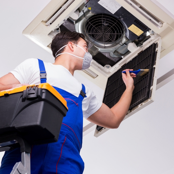 Worker Repairing Ceiling Air Conditioning Unit